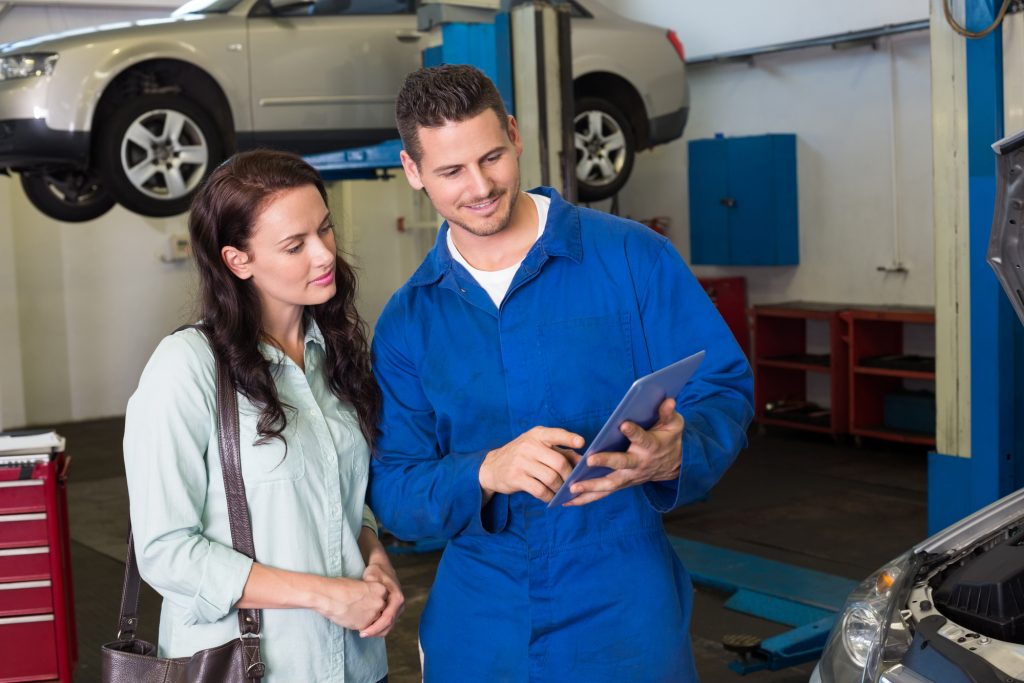 Mechanic Showing Woman Needed Car Repairs